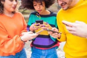 Group of multiethnic friends millennials using mobile phones